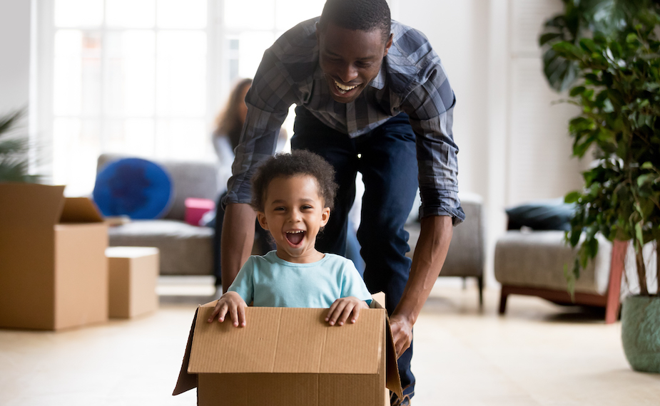 Father and son playing in moving box